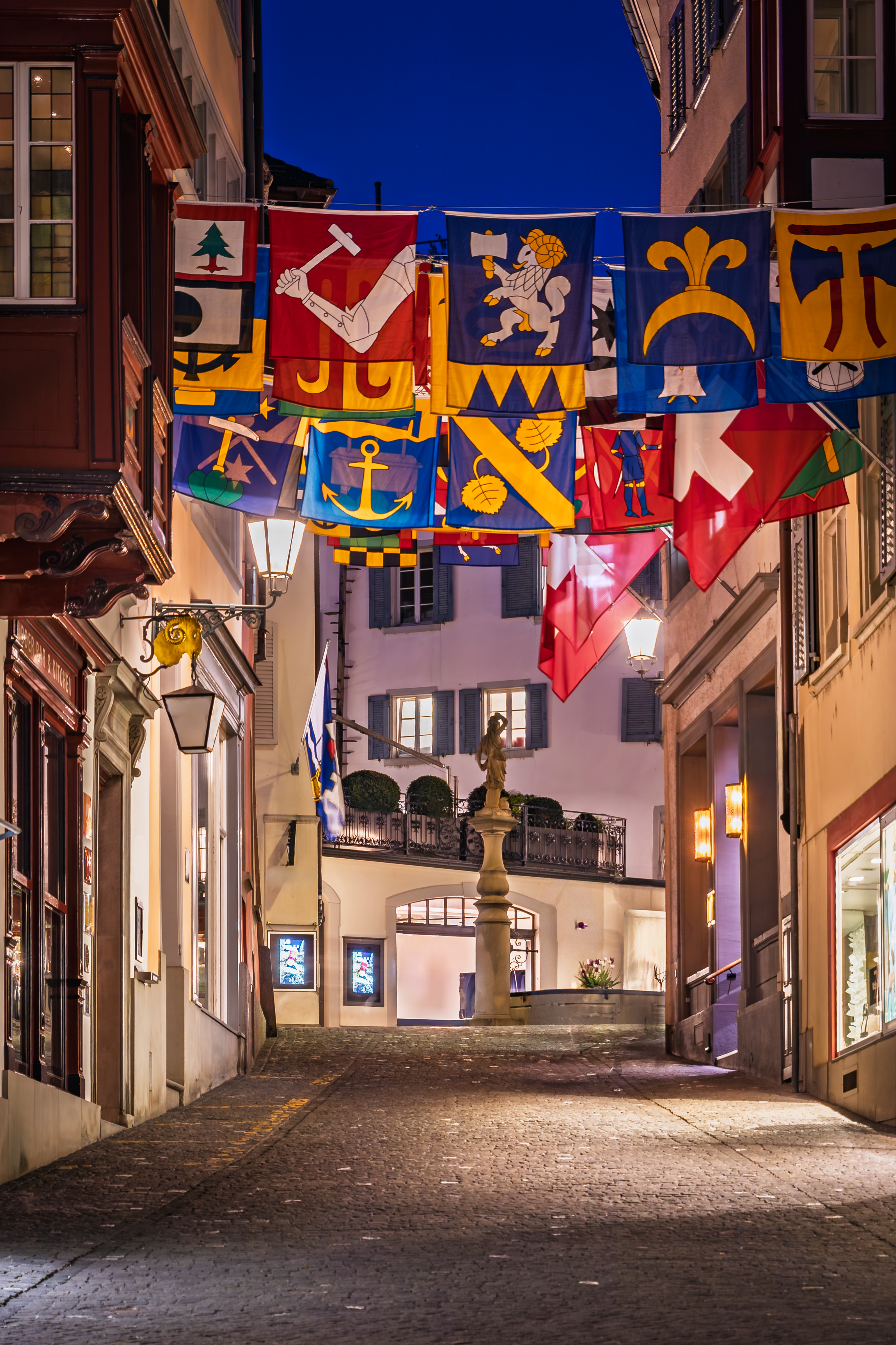 A picturesque street in historic Old Town, lined with classic buildings, traditional architecture in Altstadt, Zurich, Switzerland at sunset